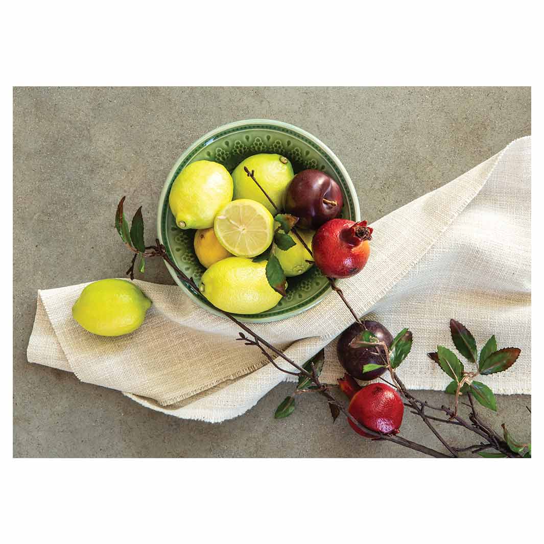 NATURAL RED POMEGRANATES AND LEMONS WITH LINEN TABLECLOTH
