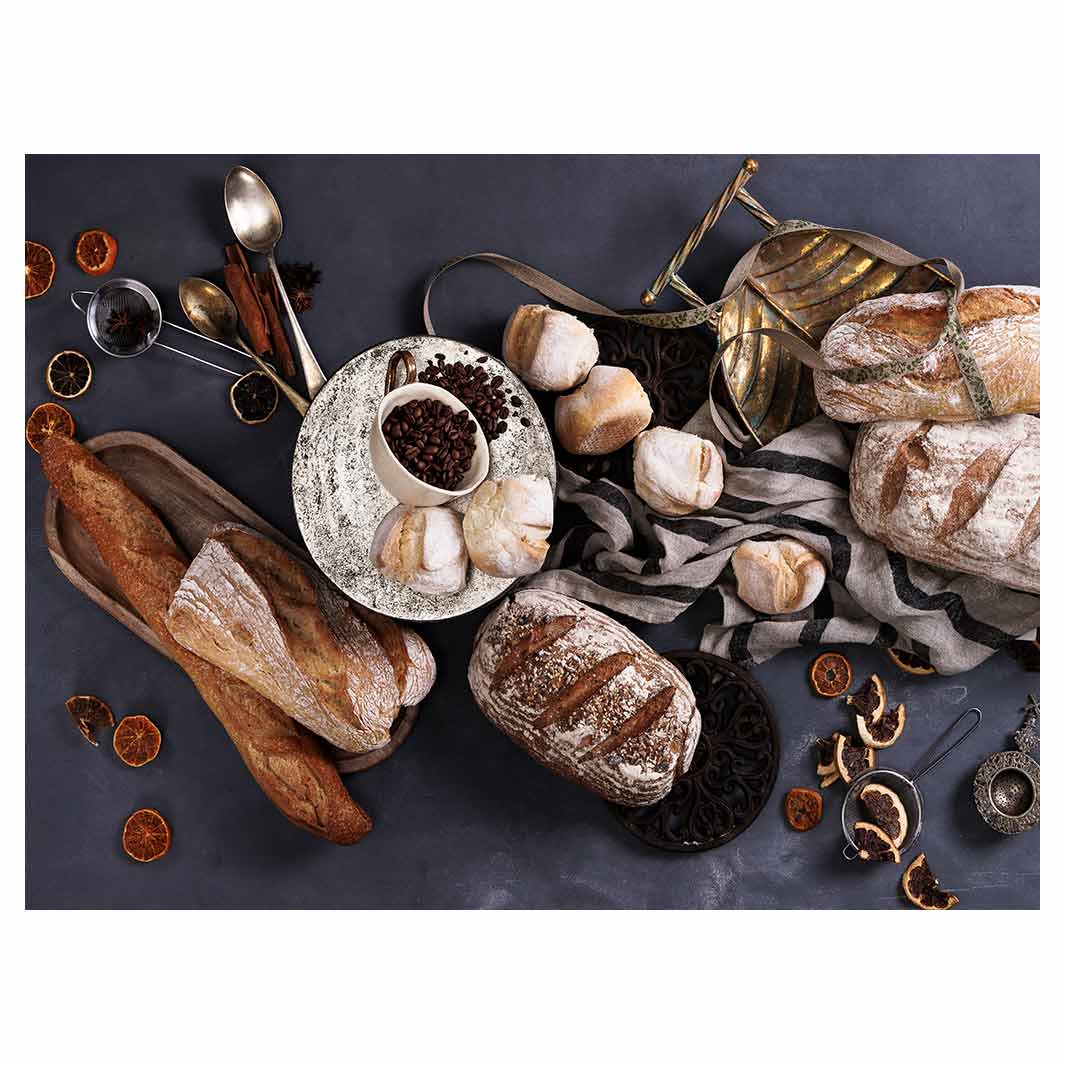 BREADS AND DRIED FRUIT ON BLACK TABLECLOTH