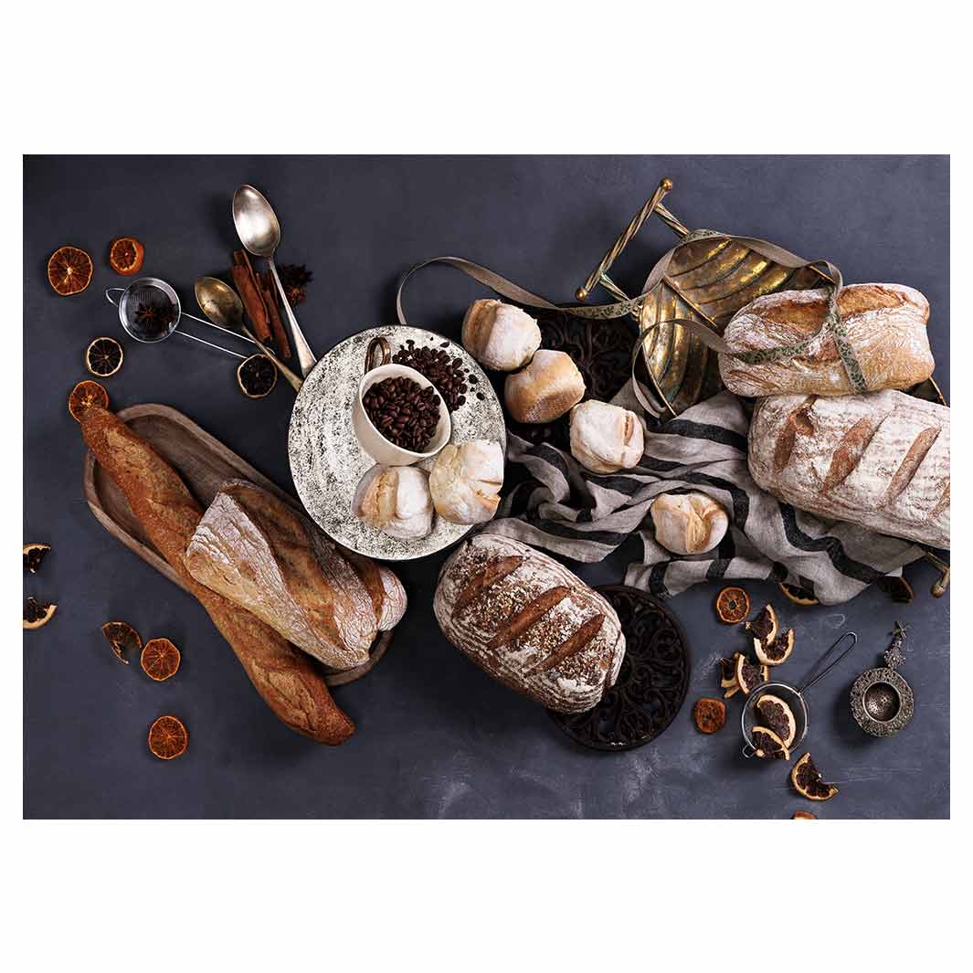 BREADS AND DRIED FRUIT ON BLACK TABLECLOTH