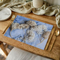 FLORAL CREAM BLEACHED HYDRANGEAS ON BLUE PLACEMAT