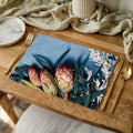 PROTEA, EUCALYPTUS AND WHITE FOLIAGE ON BLUE PLACEMAT