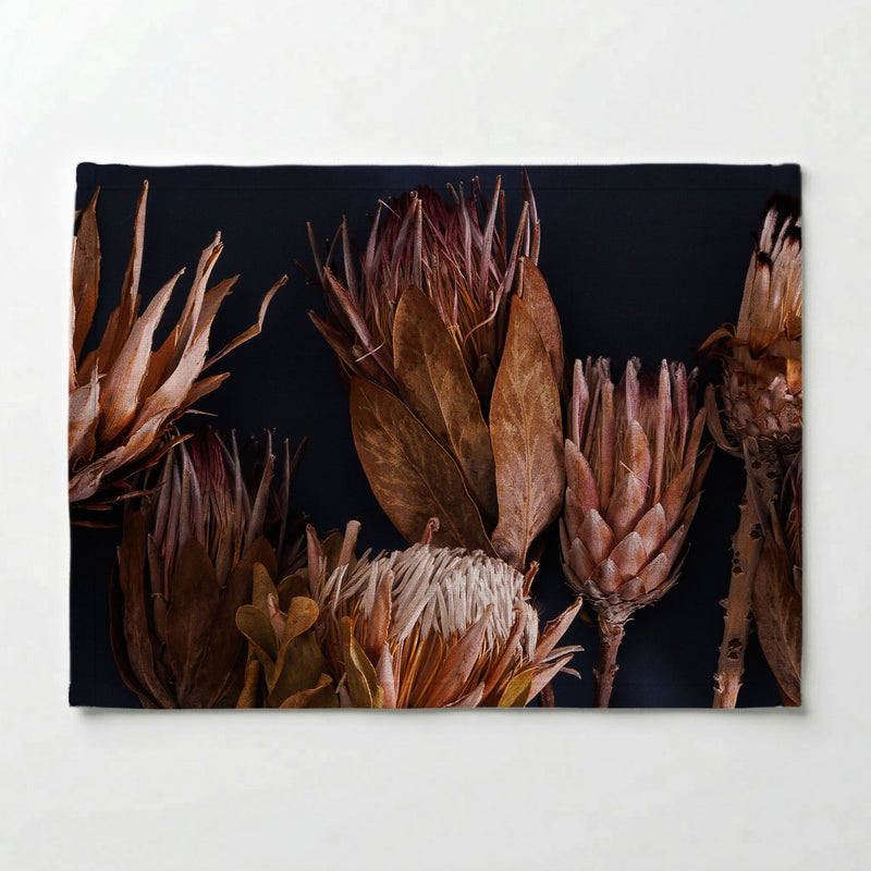 GOLDEN PROTEA ARRANGEMENT ON DARK BLUE PLACEMAT