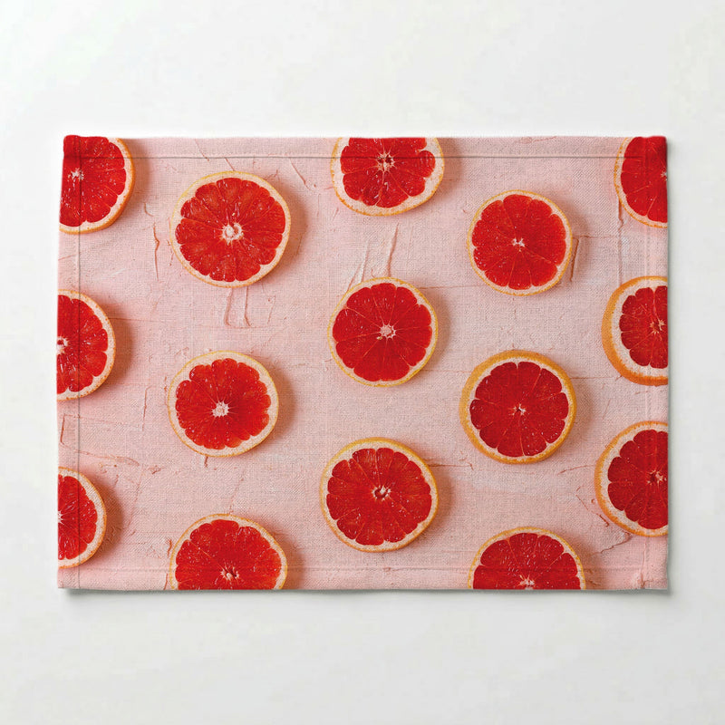 GRAPEFRUIT SLICES ON PINK PLACEMAT