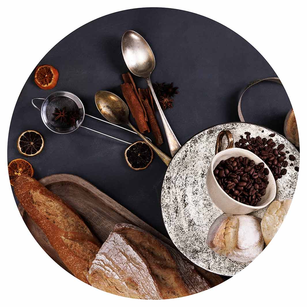 BREADS AND DRIED FRUIT ON BLACK CHEESEBOARD
