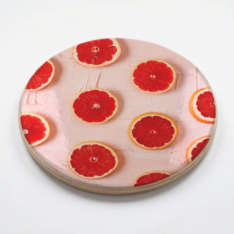 GRAPEFRUIT SLICES ON PINK CHEESEBOARD
