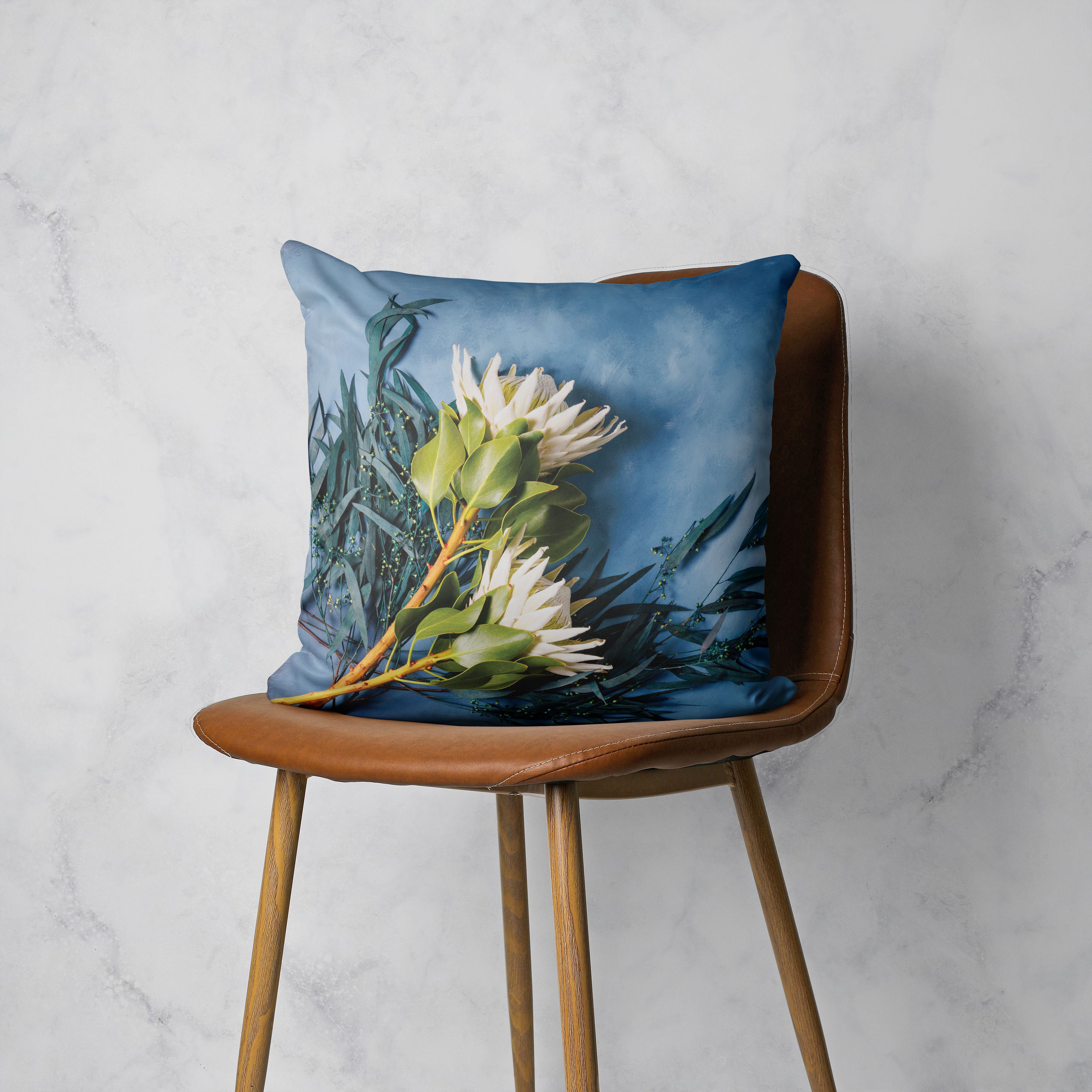 WHITE PROTEAS AND EUCALYPTUS ON BLUE SCATTER CUSHION