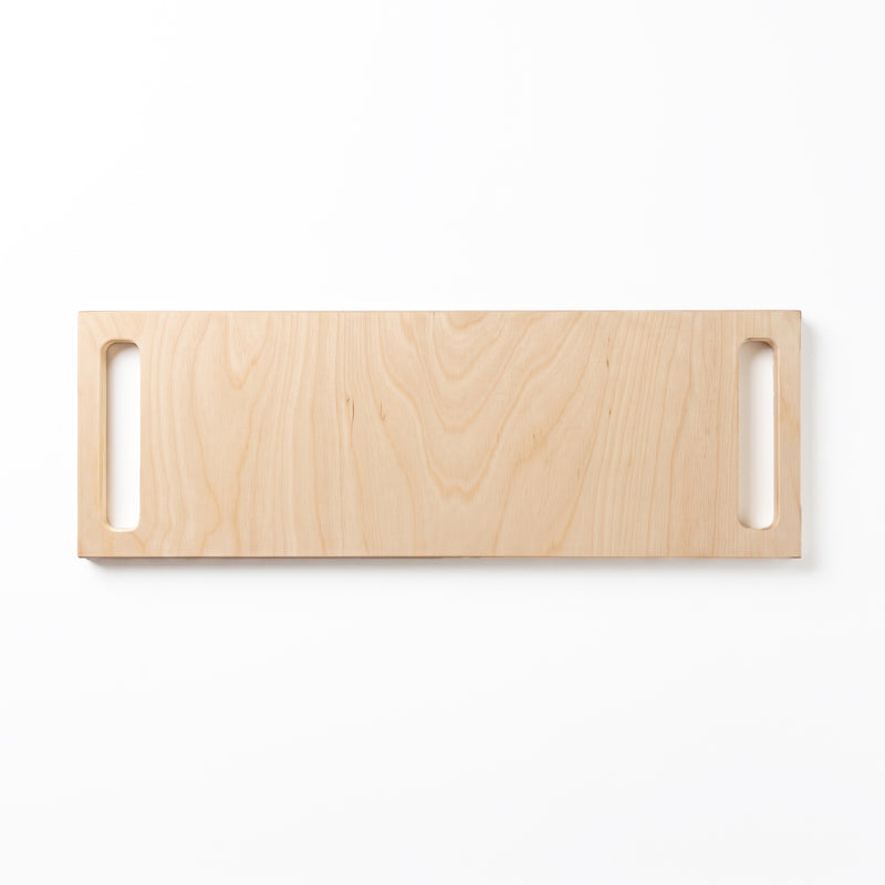 A rectangular light natural wood double-handle serving board, shown against a plain white background.