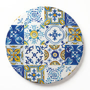 A round wooden serving board featuring a blue-and-yellow watercolour Lisbon tile print, set against a clean white background.