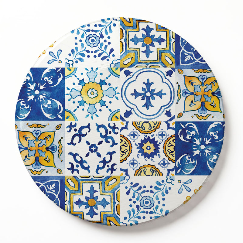 A round wooden serving board featuring a blue-and-yellow watercolour Lisbon tile print, set against a clean white background.