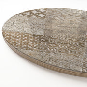 A close-up of a wooden serving board featuring a brown modern tile pattern print, with a visible layered wood edge on a white background.