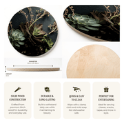 A product information graphic for a round wooden serving board with a dark green aloe and succulent print. The graphic shows two views of the printed board, a close-up of the natural birch wood edge, height and diameter measurements, and four feature callouts about solid wood construction, durability, easy cleaning, and suitability for entertaining.