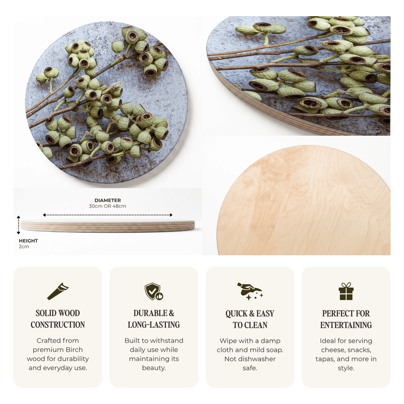A product infographic for a round wooden serving board with a printed birch wood design of green amber nuts on a weathered grey-blue background. The infographic shows two views of the board, a height and diameter measurement, and four feature callouts for solid wood construction, durability, easy cleaning, and suitability for entertaining.