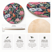 A product infographic for a round wooden serving board featuring a colourful floral print on one side and a natural light wood grain on the other. The graphic includes a dimension callout showing the board is 30cm or 48cm in diameter and 2cm thick, a close-up of the natural wood side, and four feature callouts highlighting solid wood construction, durability, easy cleaning, and suitability for entertaining.