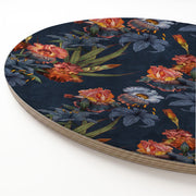 A round printed wooden board featuring a dark navy blue background with a detailed floral print of orange, pink, and blue flowers, shown on a clean white background.