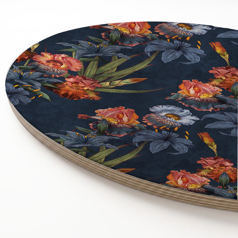 A round printed wooden board featuring a dark navy blue background with a detailed floral print of orange, pink, and blue flowers, shown on a clean white background.