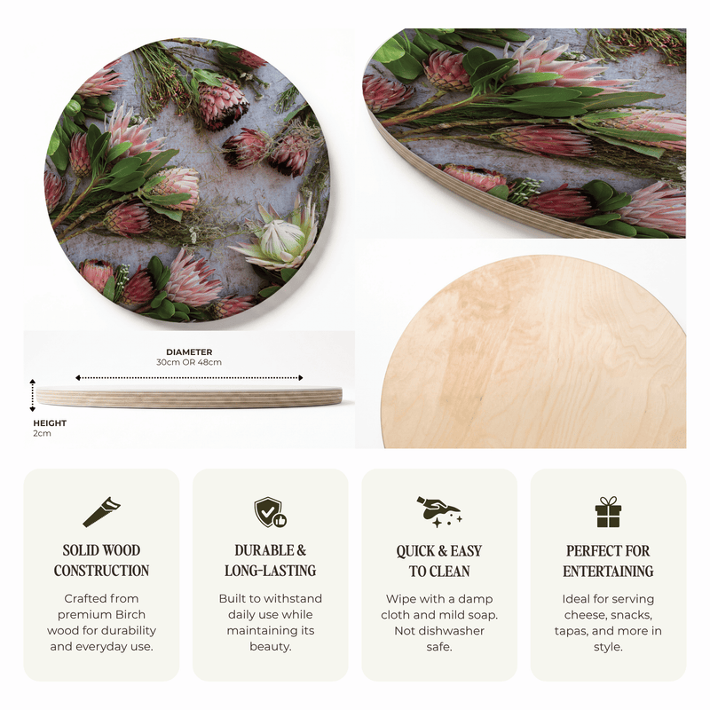 A product presentation of a round wooden serving platter with a printed botanical design of pink protea flowers and green leaves. The image includes a top-down view of the platter, a side profile showing its 30cm diameter and 2cm thickness, a close-up of the natural wood grain backing, and four feature callout boxes with text describing its solid wood construction, durability, ease of cleaning, and suitability for entertaining.