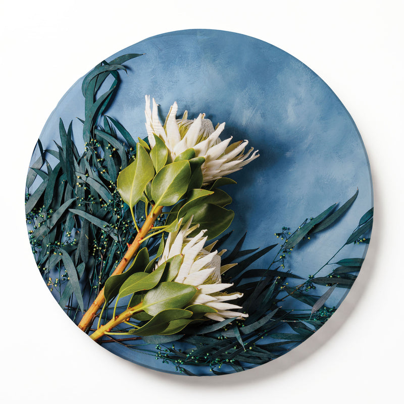 PROTEA AND EUCALYPTUS ON BLUE ROUND SERVING BOARD
