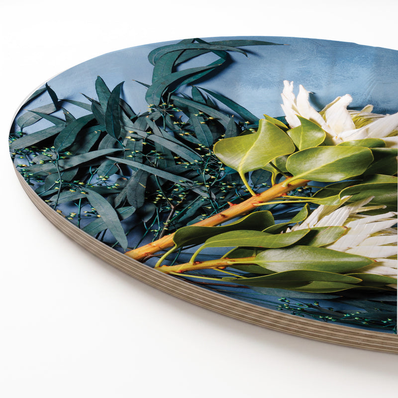 PROTEA AND EUCALYPTUS ON BLUE ROUND SERVING BOARD