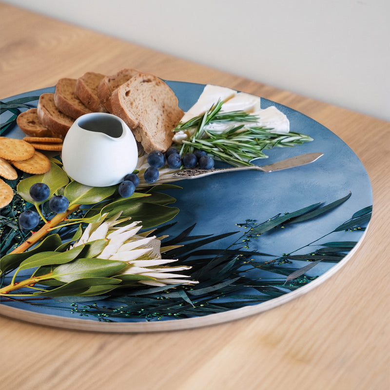 PROTEA AND EUCALYPTUS ON BLUE ROUND SERVING BOARD