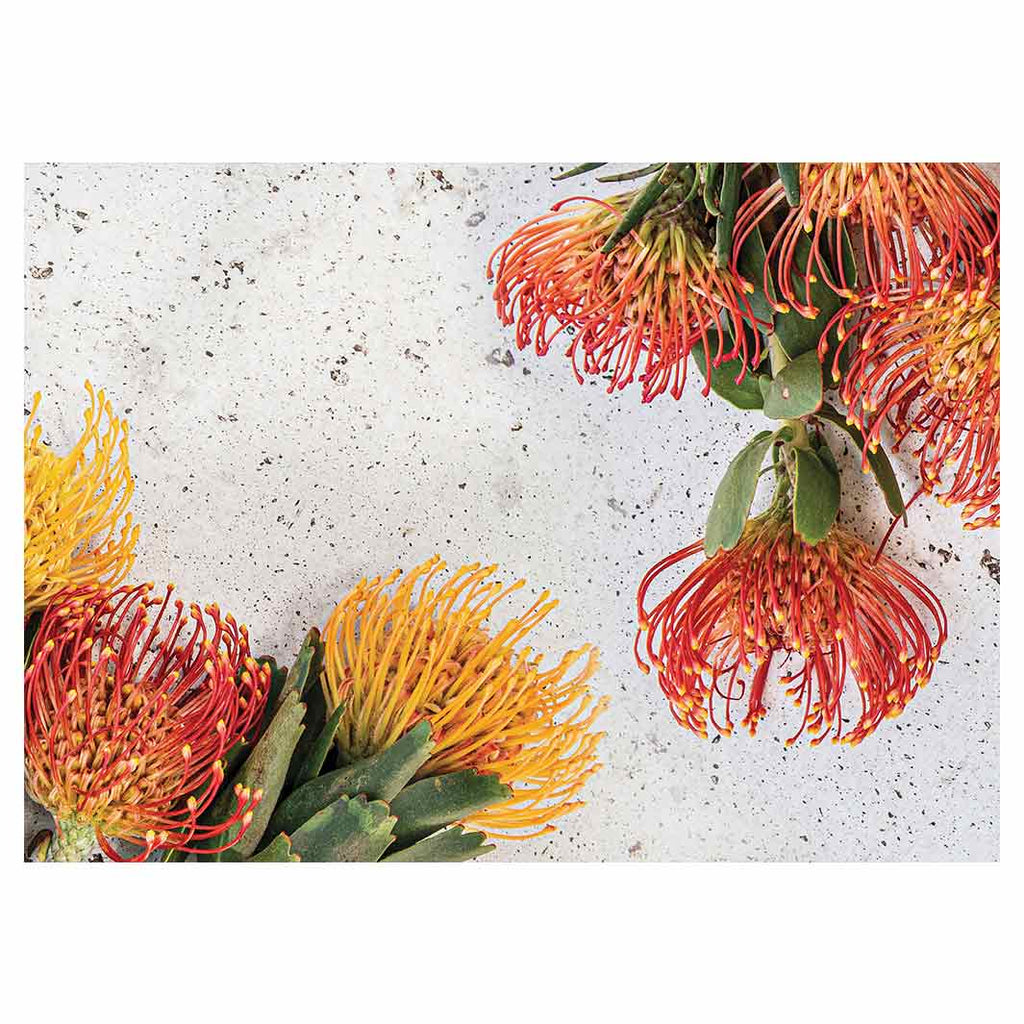 FLORAL ORANGE PIN CUSHIONS ON WHITE TABLECLOTH
