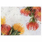 FLORAL ORANGE PIN CUSHIONS ON WHITE TABLECLOTH