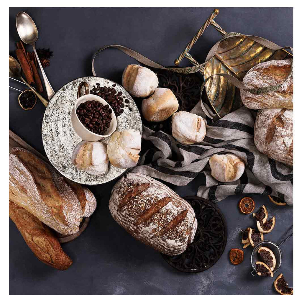 BREADS AND DRIED FRUIT ON BLACK TABLECLOTH