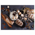 BREADS AND DRIED FRUIT ON BLACK TABLECLOTH