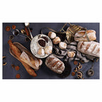 BREADS AND DRIED FRUIT ON BLACK TABLECLOTH